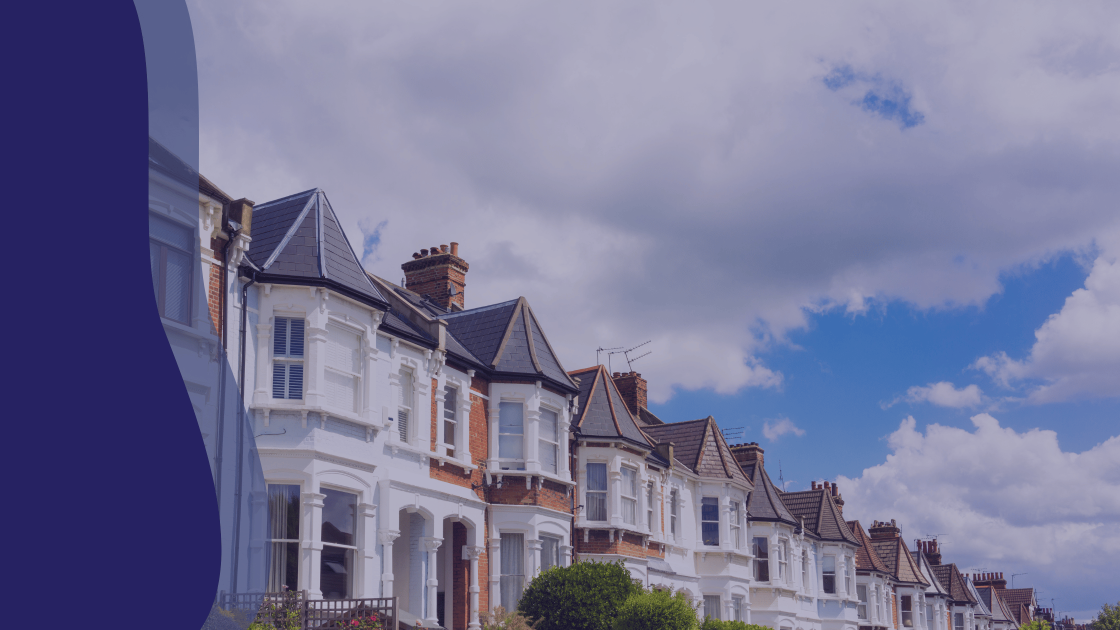 row of cookie cutter type homes with a blue and slightly cloudy background